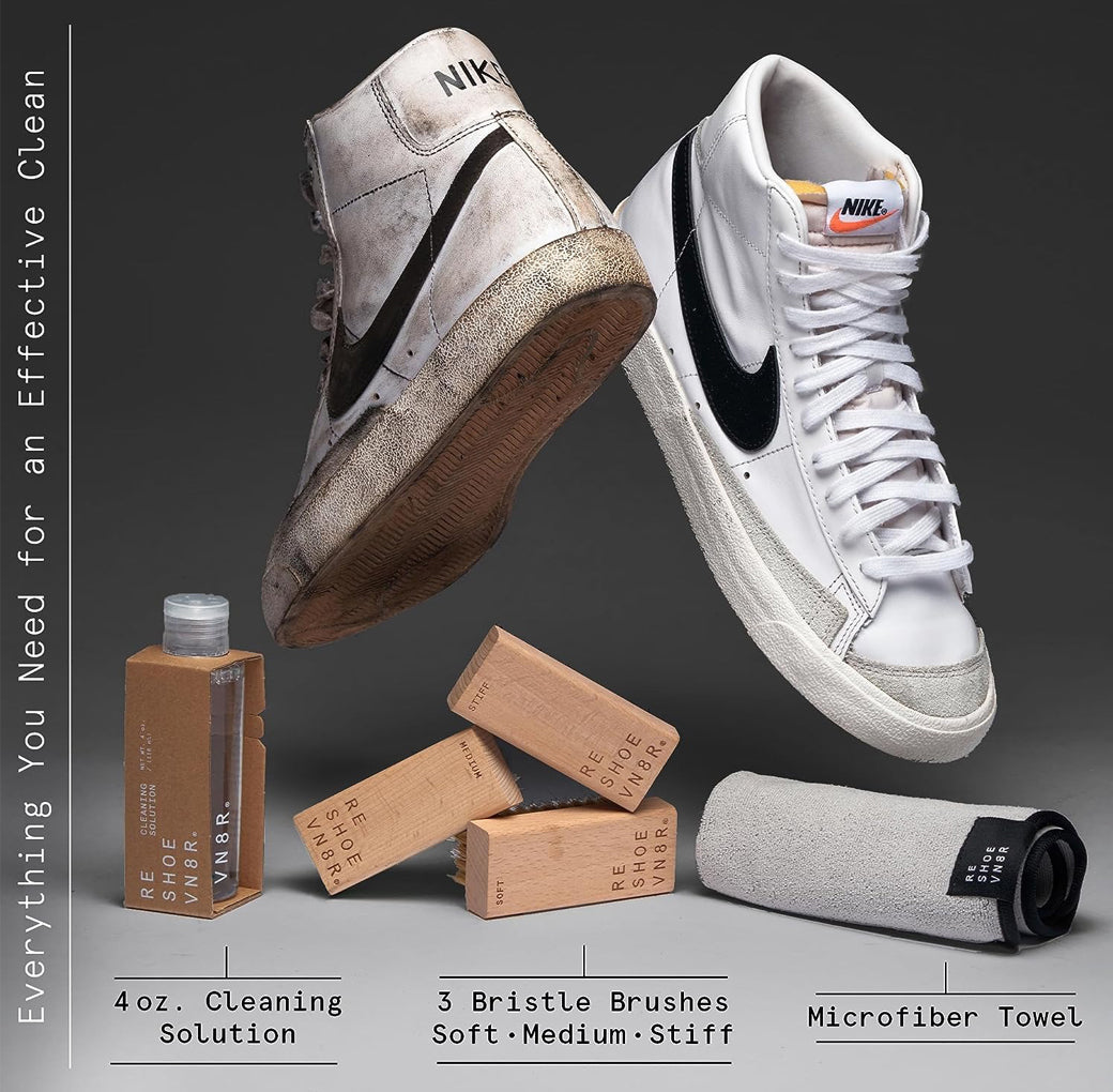 A pair of white Nike Blazer sneakers sitting on top of a box of Reshoevn8r shoe Triple supplies. The Triple supplies include a bottle of Triple solution, three bristle brushes in different softness levels, and a microfiber towel. One sneaker is clean, and the other is dirty.