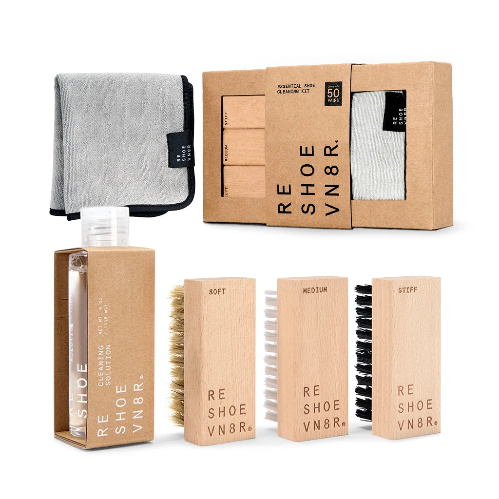 A box of Reshoevn8r shoe Triple kit containing a bottle of Triple solution, three brushes in different softness levels, and a microfiber towel  resting on a white background.